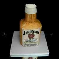 Jim Beam 4 6" cakes stacked (with Jim Beam cream between each). I carved the top on a slant and then cut off the sharp corners. Then covered...