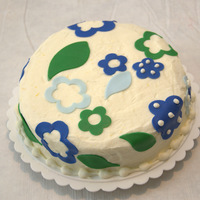 Blue And Green Flowers this cake was just for fun.... vanilla cake with raspberry filling and lemon cream cheese frosting.... the decorations are fondant!