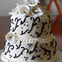 Cala Lillies this is a 2 tier cake, the cake is chocolate with chocolate ganache filling and vanilla buttercream frosting.