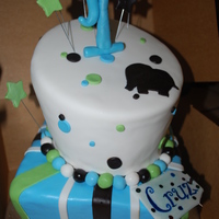 Baby's First Birthday Topsy Turvy with a square bottom tier and rounded upper tier. Done in colors of, blue, green and brown with elephant cutout to match the...