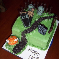 50Th Halloween Bash Buttercream frosting, fondant coffin, candy for picket fence.