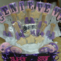 Hannah Montana Themed Bouquet Made these for my husband's 6 year old niece. NFSC and fondant. Guitars were hand cut - no cookie cutter on hand at the time. Thanks...