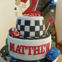 Pixar's Cars Cake Vanilla cake, strawberry filling, mmf fondant. Cars are made of styrofoam and mmf fondant. Thanks for looking! :)