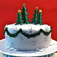 Christmas Wonderland 3d cut out trees with garland made out of royal icing and gumpaste snowflakes.