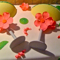 Margaritaville Cake Margarita glasses surrounded by lime wedges and pink flowers. Everything was made with gumpaste.