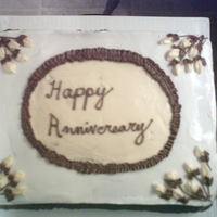 Anniversary White cake with buttercream frosting, yellow BC flowers, brown leaves and stems