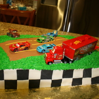 Race Cars Birthday the race tracks and the checkered black and white are made of fondant and the grass is buttercream.