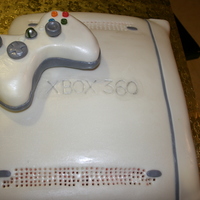 Xbox red velvet cake with cream cheese buttercream covered with white fondant shaped like an xbox. the controller is made up of rice krispies...