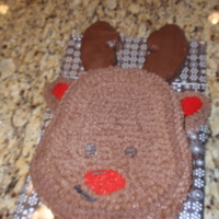 Reindeer Cake Chocolate and vanilla layers with berry filling and chocolate buttercream. The antlers are sugar cookies coated in chocolate.