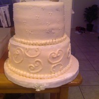 Ivory Pearls Round Ivory buttercream 2 tier. Took this pic before I fixed the mistakes.