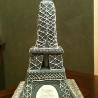 Eiffel Tower Cake Bottom tier is vanilla bean cake with layers of vanilla custard and chocolate ganache filling, covered in fondant. The tower is RKT covered...