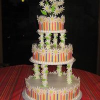 Sid's Daisies This was a graduation cake for my husband's cousin. The design came from the Wilton tiered cakes book (she picked it out).