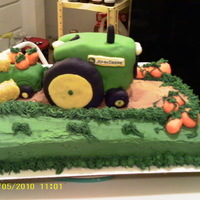 John Deere Small John Deere tractor and wagon. Pumpkins are fondant. Straw bales are cake chunks covered with frosting and tinted coconut.