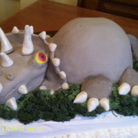 Dinosauer Fondant covered with fondant accents.