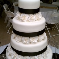 Lindsay And Coty's Wedding WASC and Strawberry cake w/ bc frosting, covered in MMF, with MMF roses and black ribbon. Thanks for looking!