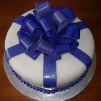 Shimmer Bow Cake This is a 10" round white cake wrapped in fondant topped with a bow. First bow. Lesson learned = allow enough drying time and mix in...
