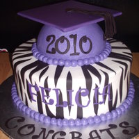 Graduation Cake half 6in ball and 10inch round... buttercream with fondant zebra stripes, tassel and letters.. The cap was card board covered with fondant...