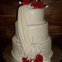 Wedding Cake red and white roses, lilies, vanilla cake with a cream cheese filling