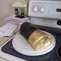 Shotgun Shell Cake Jack Daniels Whiskey Cake with milk chocolate frosting. Done as a cake roll and it ended up collapsing a little which made it more oval...