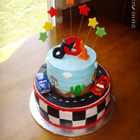 Disney's Cars Cake This cake is a 2 tier cake covered with buttercream icing with fondant accents. The cars are the only thing non edible.