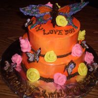 Orange Anniversary Cake buttercreme icing with chocolate buterflies and fondant roses