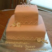 Grandma's 90Th Birthday Bottom is butter pecan, top is lemon. Covered in fondant with gum paste flowers.