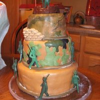 Camo Cake This a layered store bought chocolate cake, we used MMF to do the camo. The figurines wer purchased at a store.