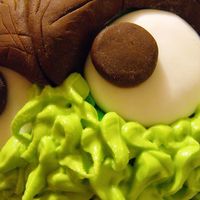 Oscar The Grouch And His Pal Slimey 32cm Tall. Banana Cake, Lemon Icing. Fondant Accents, the top fur layer of his face and hand is royal icing.