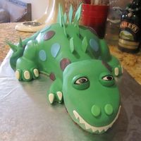 Sculpted Dinosaur Birthday Cake I used 2 - 2 layer 9" rounds to sculpt this cake. Added fondant hips and feet before covering with mmf.