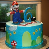 Mario Small Mario cake with cupcakes. All edible as it was for a child. Gumpaste figurines & number and use chocolate for his name.