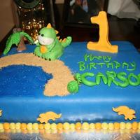 Dinosaur Cake White WASC, chocolate buttercream, everything made out of fondant (water is blue piping gel, sand is graham cracker crumbs)