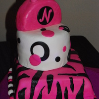 Sweet 16 Cake MMF, purse is rice krispee treat coated in chocolate melts under the MMF. Handle is gumpaste.