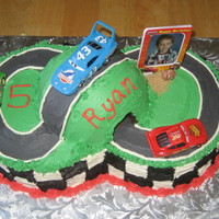 Cars Race Track (2) 8inch cakes w/ the Wilton Sports Ball for tunnel. Got inspiration from other cake central members. Thanks for looking