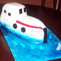 Boat Boat cake with a shark in the water.