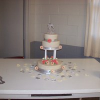 Calla Lilies And Roses 3 tier cake- roses are coral colored and painted with a silver and pink blend of shimmer dustCalla lilies are ivory with the edges dusted a...