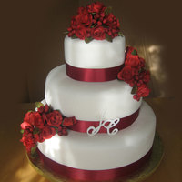 Roses/christmas Preview 14",10" and 6". Fondant roses, berries and leaves.The bride wanted red roses, the venue was going to be decorated red and...