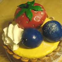 Fruit Tart Cake Vanilla rum cake in the body, strawberry-chocolate cake in the strawberry, berry cream and chocolate cake in the berries. MMF fondant.