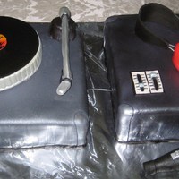 Turntable, Headphones, And Mic Cake The left side of the cake is an organic carrot cake with cream cheese frosting. Fondant is used to cover the entire cake. The record part...