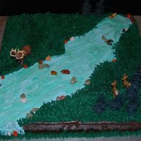 Deer Hunting 17" sheet cake covered in chocolate syrup frosting and then decorated with buttercream. The trees and animals are from a kit. I really...