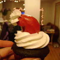 First Time Making Santa Hat Cupcakes Used red chocolate clay for the hat. Butter cream frosting for the white of his hat.