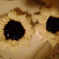 Flower Cupcakes Lemon cake with blackberry jam and cream cheese frosting. I played around making a sun flower with the jam being the center of the flower...