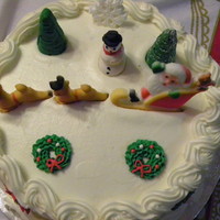 Christmas Cake. Chocolate cake with white chocolate truffle filling and buttercream frosting. Royal icing and fondant accents.