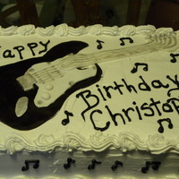 Son's Birthday Cake Vanilla and Chocolate cake with Whip cream frosting and fondant guitar.