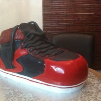 Groove Tennis Shoe Chocolate cake with buttercream icing and filling. Red and black fondant. Detailed work painted on.