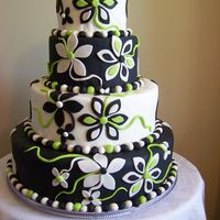 Lime Flower Fun! This black and white fondant tier is covered in whimsical flowers with a touch of lime green added. The fondant dot border add a nice touch...
