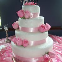 Pretty In Pink Brides love this fonant design! This cake is finished off with pink ribbon and roses.
