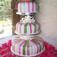 Floating Tiers Of Fun! I love this cake! Ribbon is so fun!!! The fondant bows float on the bottom 2 tiers as rock candy adores the top!