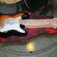 Guitar Cake Chocolate cake covered in fondant. Gumpaste guitar parts.