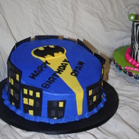 Batman Cake 10in rainbow colored WASC with strawberry filling. Buttercream with MMF accents.