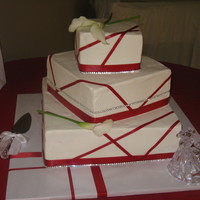 Red And White Buttercream frosting with red ribbon and rhinestone accents.